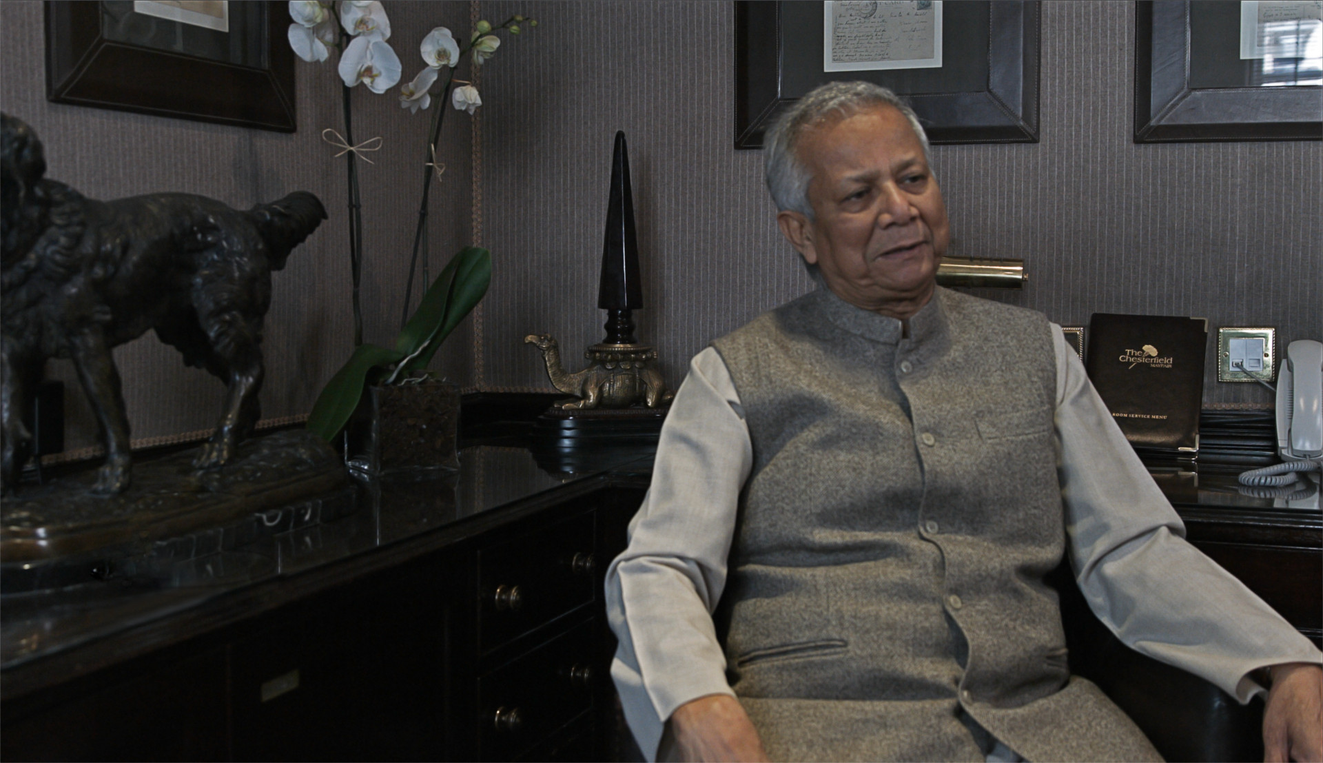 Disparity film still, Muhammad Yunus sitting